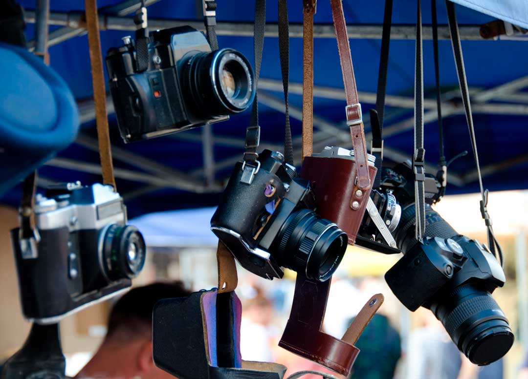 the-marketplace-vintage cameras hanging from market booth AdobeStock_93778957